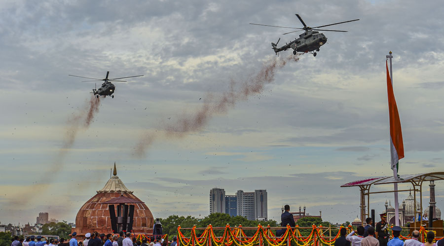 MI-17 helicopters shower flower petals during the 76th Independence Day function at the Red Fort, in New Delhi on Monday.