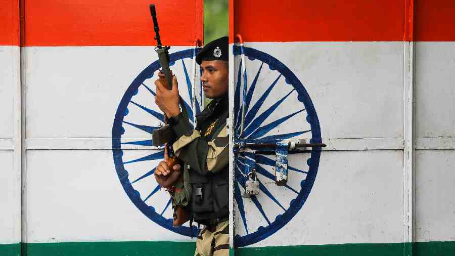 A Border Security Force personnel stands guard at the Octroi Post Suchetgarh on the occasion of 75th Independence Day celebrations, on the outskirts of Jammu. 