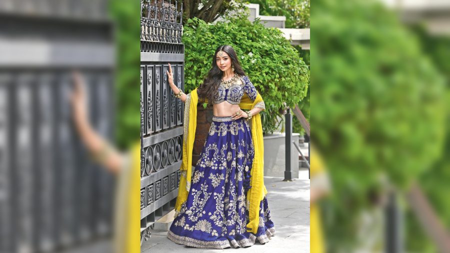 For the afternoon to evening sangeet look, Diti donned a classy and royal purple lehnga from Jayanti Reddy Label. The intricately embellished lehnga is contrasted with a yellow embellished dupatta, adding colour drama to the look. The polki jewellery and hair worn open enhance the elegance of the ethnic look.