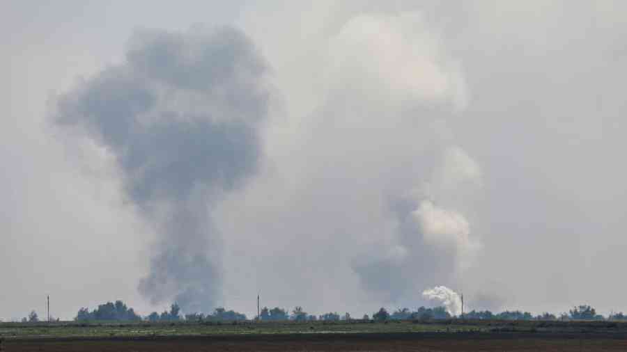Plumes of smoke rise after explosions in the Dzhankoi district of Crimea on Tuesday.