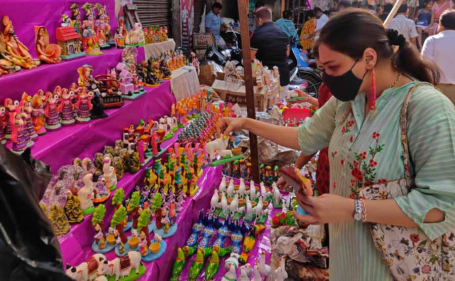 A woman looks at figurines depicting scenes from Lord Krishna's childhood at a stall in Burrabazar on Wednesday, ahead of the Janmashtami festival on August 19. Janmashtami marks the birth anniversary of Krishna in Hindu mythology.