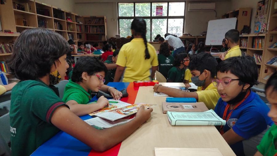 The students of Mahadevi Birla World Academy read to the children of Calcutta Social Project