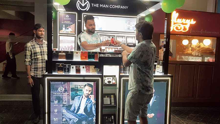 A customer checks out products at The Man Company kiosk in City Centre. 