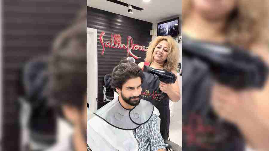 A man gets his hair styled at Satin Rose in FE Block