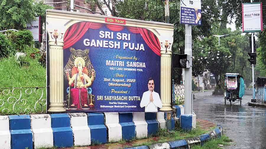 A banner announces the eighth edition of the Maitri Sangha Ganesh Puja with a picture of reinstated president Sabyasachi Dutta. 