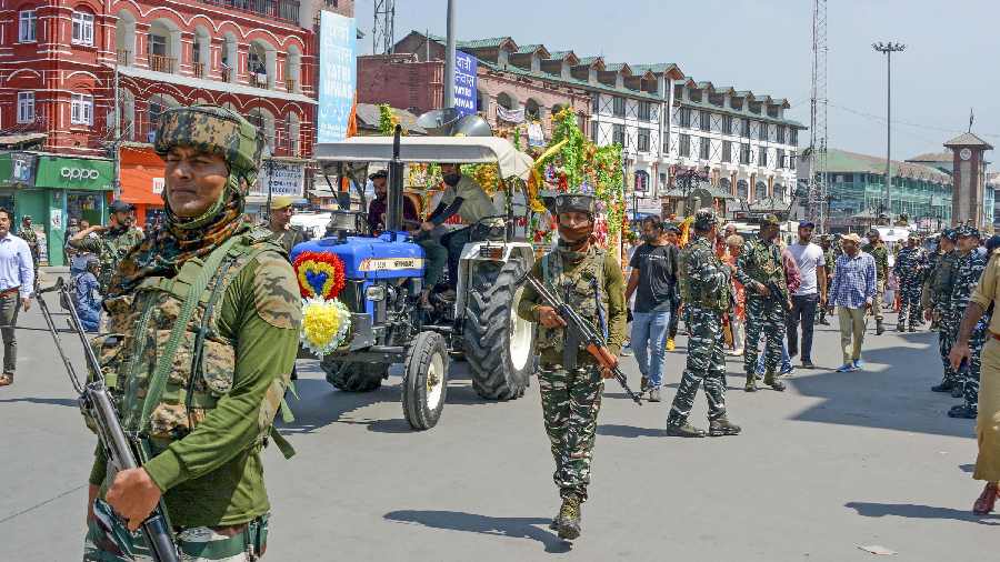 Security personnel keep watch during a religious procession in Srinagar