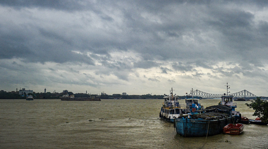 Vessels are seen anchored in the Ganga river as dark clouds hover over, during the monsoon season in Calcutta on Friday