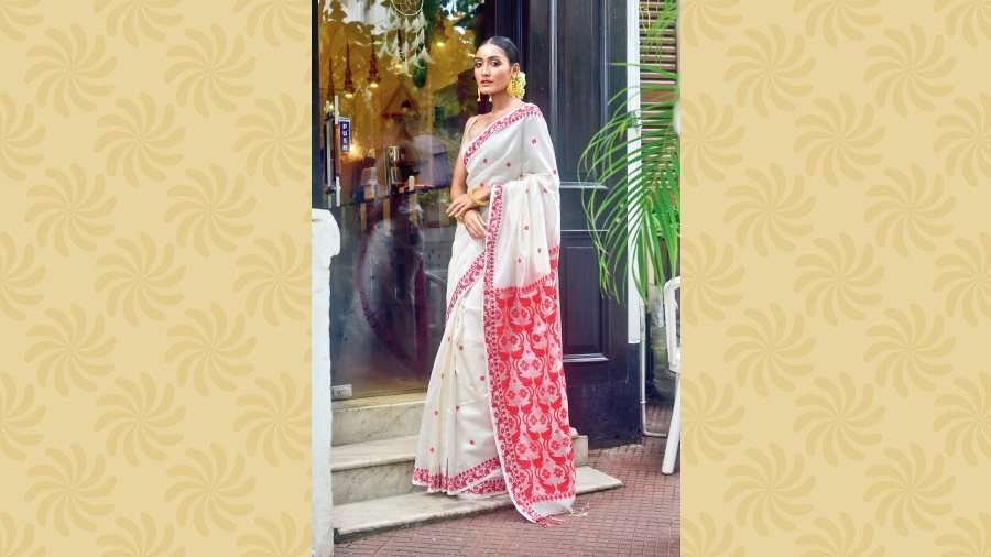 Handwoven tussore silk traditional white sari with hand-embroidered red border and pallu. Price: Rs 12,000