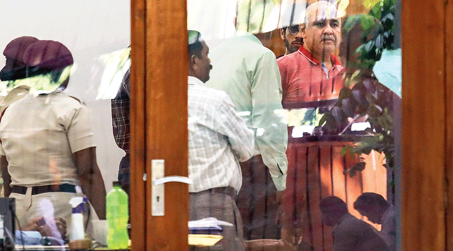 Delhi deputy chief minister Manish Sisodia with CBI officials at his residence in New Delhi on Friday.