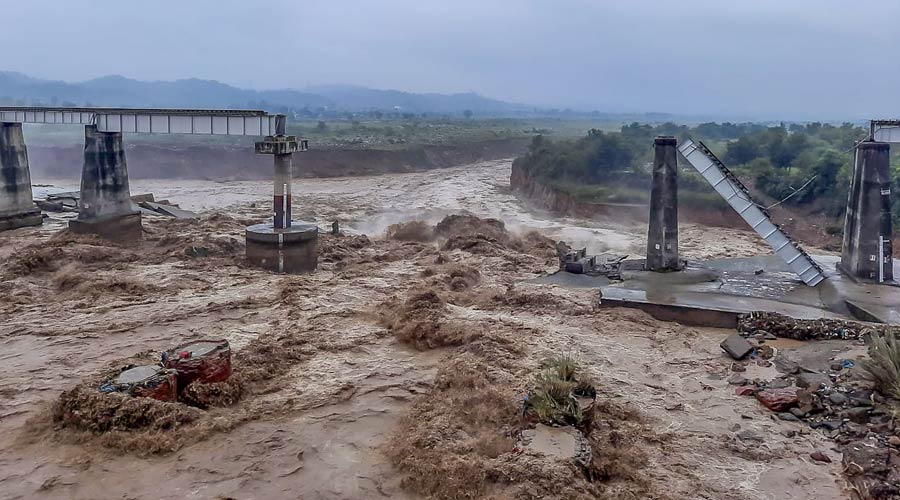 Collapsed portion of railway bridge over the Chakki river after flash flood triggered by heavy monsoon rains in Dharamshala.