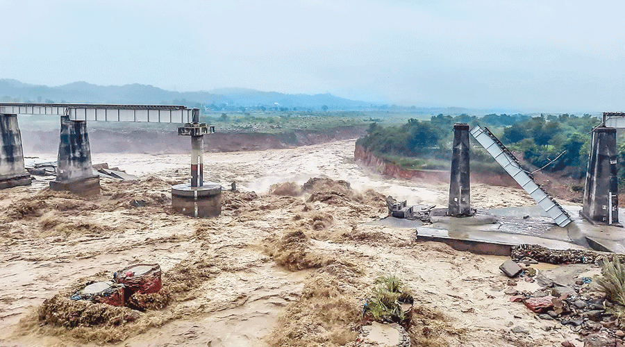A collapsed railway bridge over the Chakki river in Dharamshala on Saturday after the flash flood.