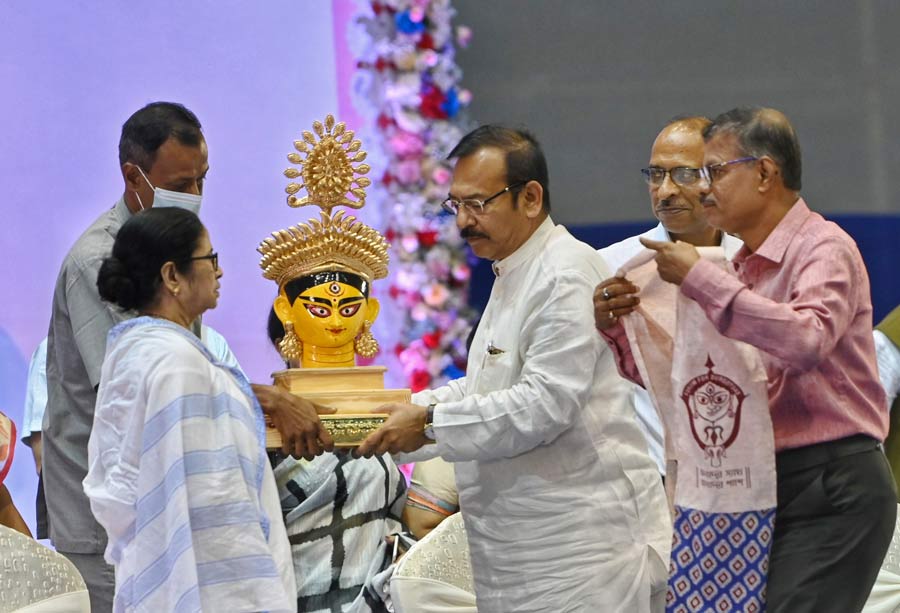 West Bengal chief minister Mamata Banerjee at a meeting at the Netaji Indoor Stadium on Monday. She announced Rs 60,000 cash bonanza for the puja organisers throughout the state.
