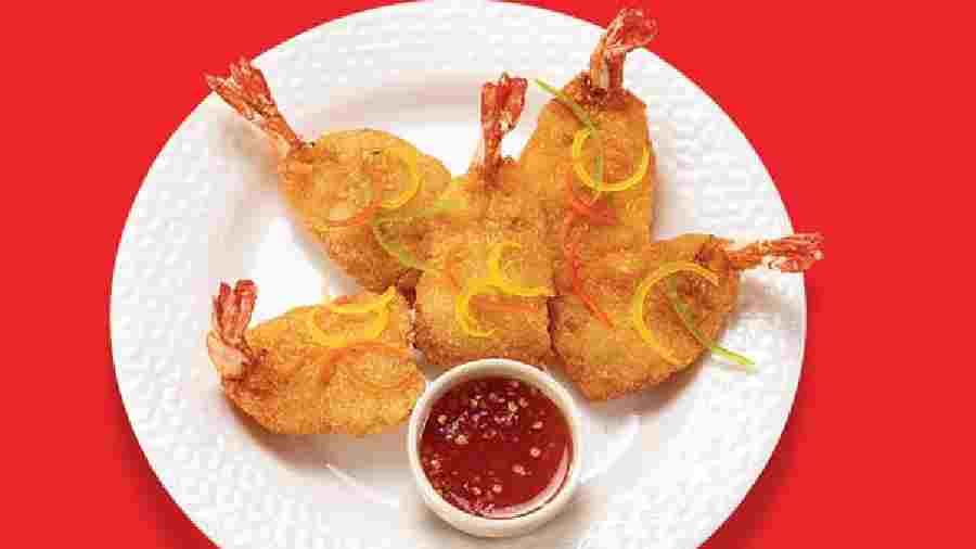 Butterfly Prawns: This dish has crumb-coated sweet-water prawns, irresistible for its freshness, which is served with Sambal sauce and Dijon mustard mayo that spices up the dish. Rs 345