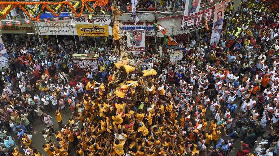 Devotees form a human pyramid to break the dahi handi at Dadar in Mumbai