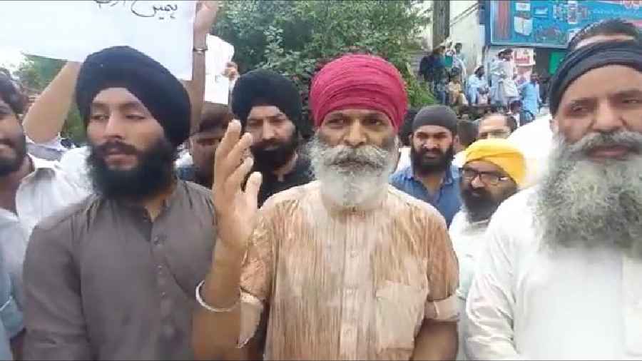 Members of Sikh community staged a protest in Pakistan's Khyber Pakhtunkhwa province on Tuesday
