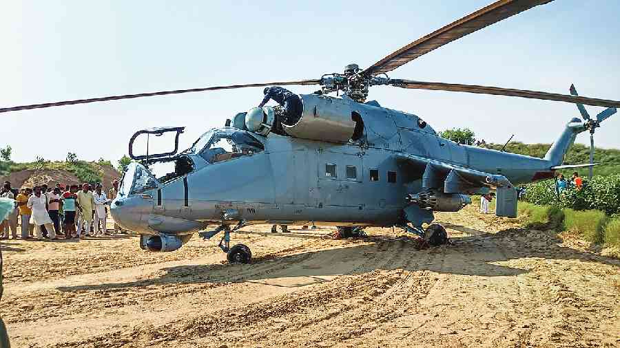 An IAF helicopter makes an emergency landing at a farm in Rajasthan’s Hanumangarh on Tuesday  due to a technical snag . 
