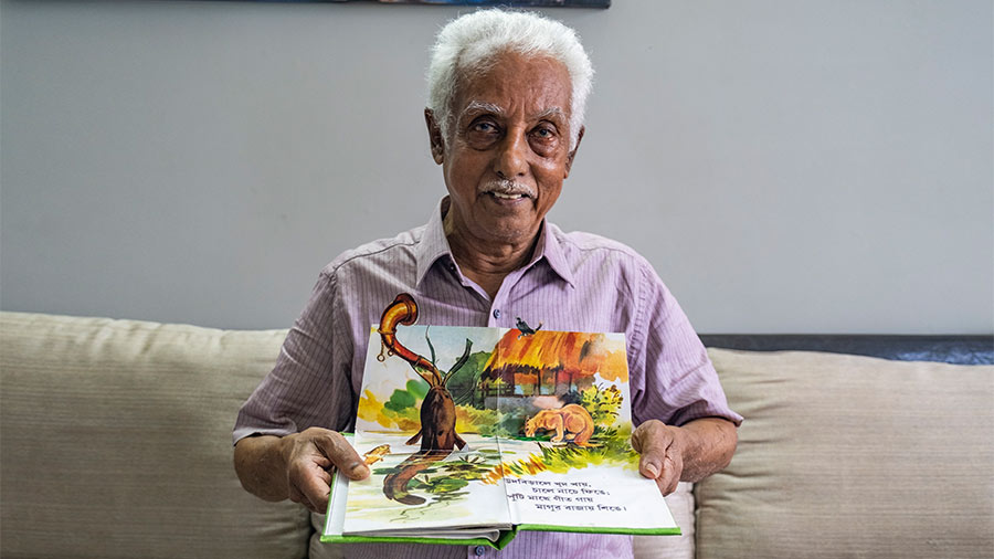Pradip Sengupta with the pop-up book on Chorar Chobi that he made for his granddaughter Myra