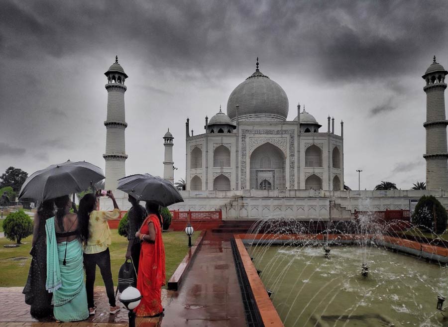 People click photos of a ‘Taj Mahal’ replica inside New Town Eco Park on a rainy Wednesday afternoon. 
