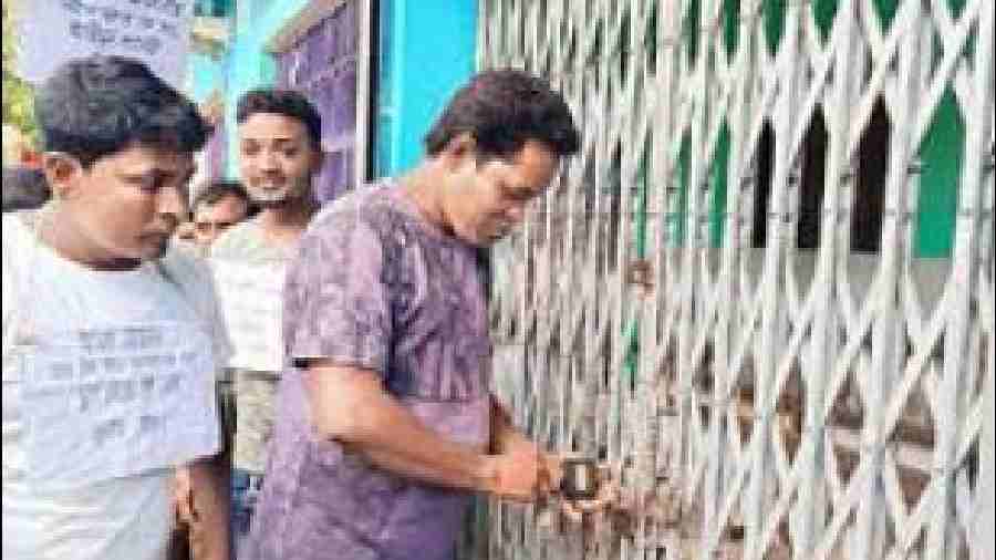 A villager locks up the Chapali gram panchayat office on Wednesday. 