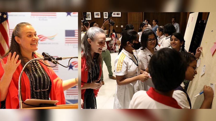 Teams prepare for their presentation as US consul-general Melinda Pavek looks on and (right) Pavek speaks after the performances  