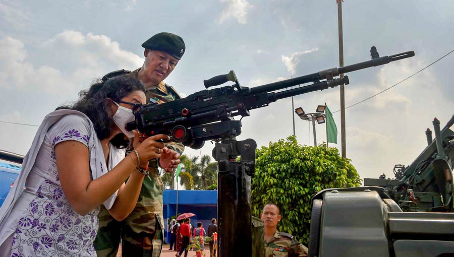 A visitor looks through the scope mounted on a gun during a weapons exhibition on Friday.