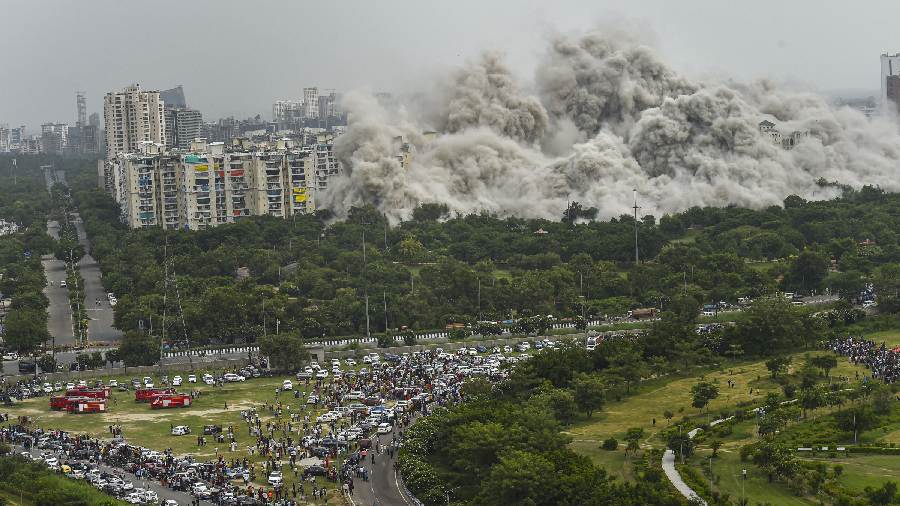 Spectators watch in awe as the towers fall down like a pack of cards