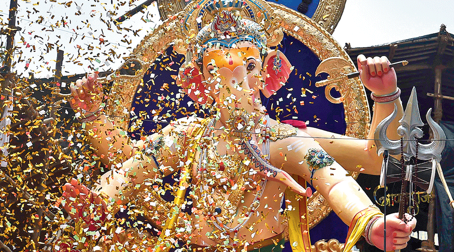A Ganesh idol being carried by devotees at a procession in Mumbai on Sunday.