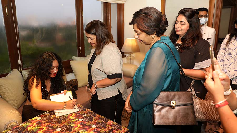 Chatterjee signing copies of her book after the discussion