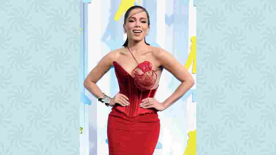 Singer Annita got everyone talking about her outfit for sure! She strutted wearing a bold red Schiaparelli gown with a corset that bared one of her breasts, which was covered up in a sort of red web 3D structure that was sure risque! Velvet fabric, six inches high heels and a short slit only added to her raunchy attire.