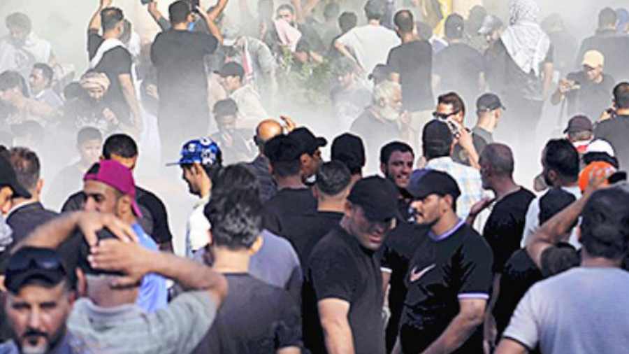  Iraqi security forces fire tear gas on Shia cleric Muqtada al-Sadr’s followers inside the government palace in Baghdad on Monday.