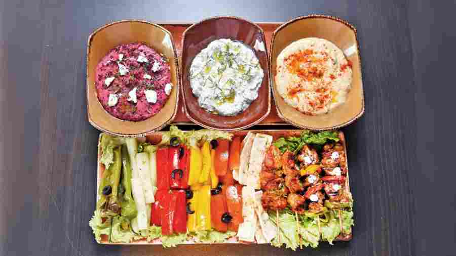 Mezze Platter: This sharing platter has assorted veggies such as bell pepper, cucumber, falafel kebabs and three different types of dips such as Beiruti hummus, betroot hummus and Tzatziki. Rs 675--plus
