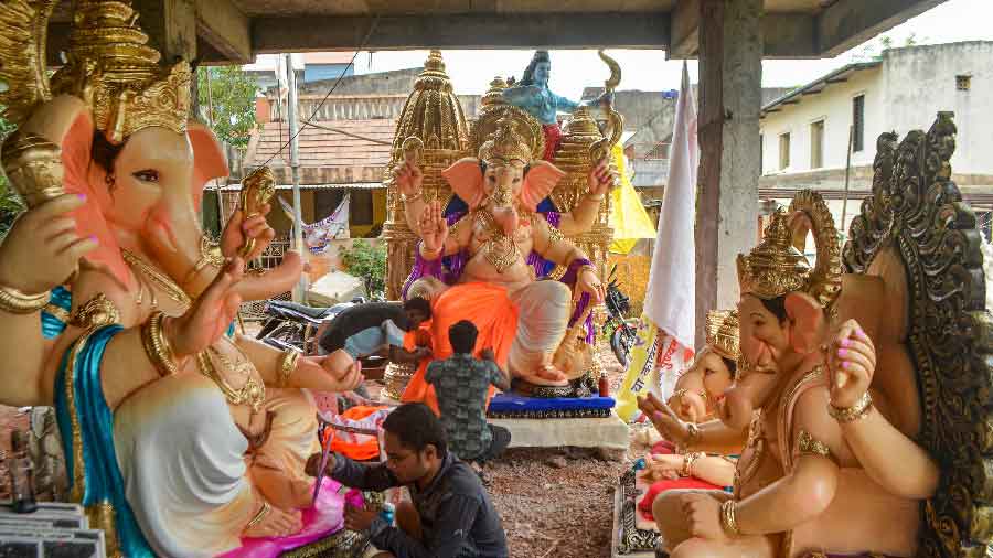 Artisans give final touches to idols of Lord Ganesha ahead of the upcoming festival of Ganesh Chaturthi, in Karad