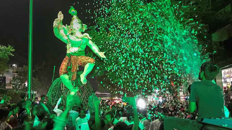 Devotes carry an idol of Lord Ganesha during a procession ahead of Ganesh Chaturthi festival in Surat