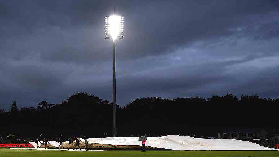 Ground staff cover the pitch during the final ODI between India and New Zealand in Christchurch on Wednesday.