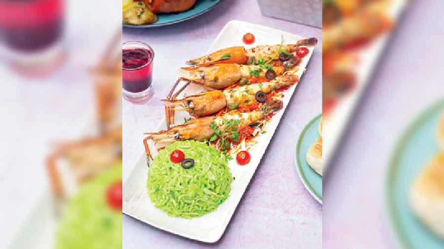 Prawn Marinara: Marinated grilled prawns tossed in tangy marinara sauce make for one heck of a meal. It is served with flavourful cilantro rice, which adds a splash of colour to the dish.
