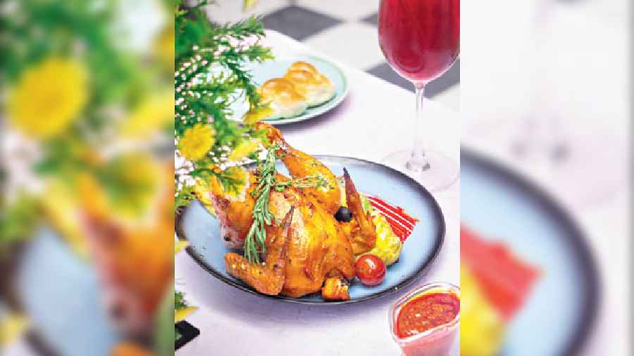 Portuguese Style Grilled Chicken: Juicy whole grilled chicken marinated with piri piri and served with baked potato, soft bread rolls and spicy peri peri sauce is hard to resist for all foodies. Be sure to share this wholesome platter with your gang!