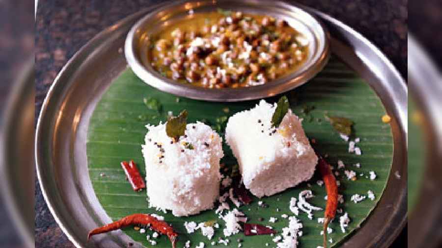 Rice and coconut mixed together in a cylindrical shape called Puttu, served with Kadala Curry made with red chana dal.