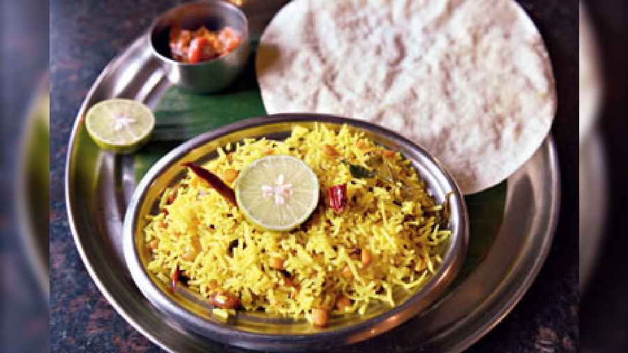 An aromatic Lemon Rice made with Basmati rice, lemon juice, ginger, sauteed peanuts and a pinch of turmeric to add the colour. Served with papad and achaar.