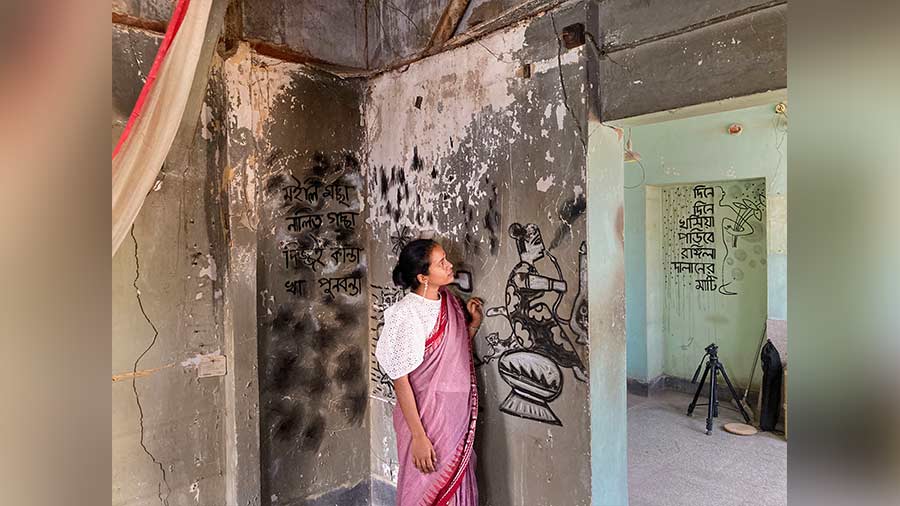 A woman inspects the artwork inside the 120-year-old house