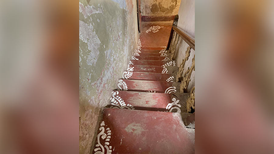  'Alpana' painted on the red-oxidised stairs of the house