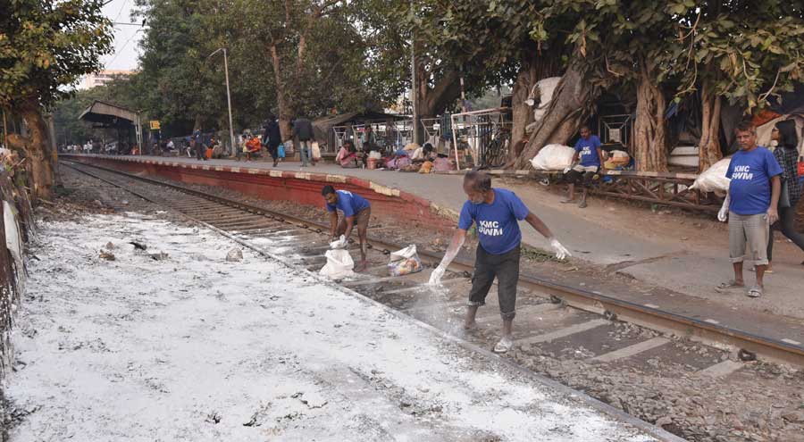 KMC workers spread bleaching powder at Bajhe Kadamtala Ghat on Thursday