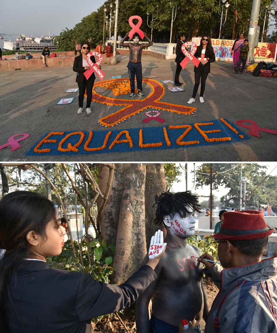 (Top) Demonstrators pose with slogans in an AIDS awareness presentation in Kolkata. (Bottom) A man paints slogans on the body of a demonstrator. December 1 is observed as World AIDS Day globally to raise public awareness about the syndrome