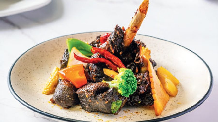 Mongolian Chili Roasted Duck: Mongolian-inspired duck meat preparation tossed with yellow bell pepper in an intensely spicy mix of sauces, garnished with dry chillies.