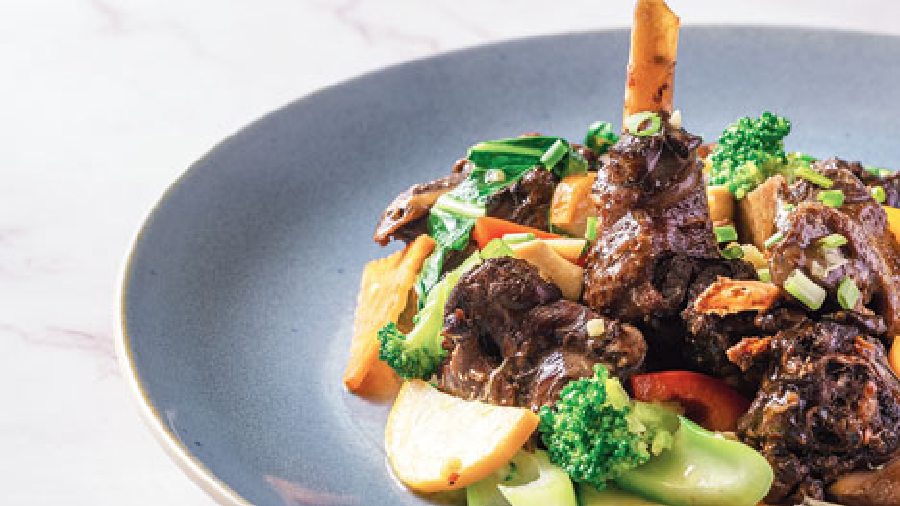 Braised Duck with Exotic Vegetables: Roasted duck meat with assorted vegetables, button mushrooms, baby corn, stir-fried and tossed in butter and white wine.