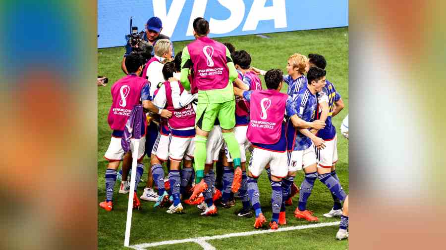 Japan players celebrate after scoring the second goal against Spain on Friday.