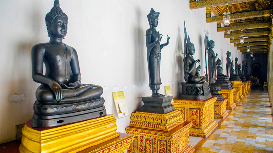 Buddha statue beneath the cloister wall 