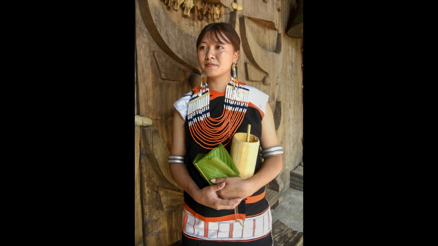 A Naga tribal woman wearing traditional dress and ornaments during inaugural day of the festival. 