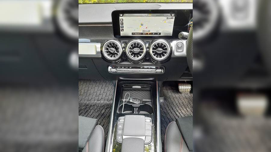 The central console sports a big touchscreen as well as touchpad controllers and wireless charger