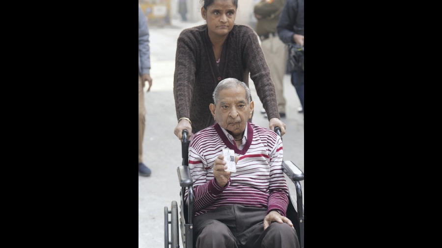 A wheelchair bound voter arrives to cast his vote for the elections. 
