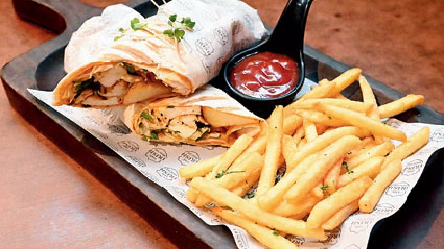 Grilled Cottage Cheese Wrap @The Irish House: This wrap is served with garlic fries and comprises harissa mayo spread, spiced grilled cottage cheese, lettuce, and potato wedges